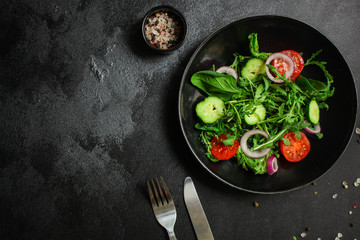 Healthy salad, leaves mix salad (mix micro greens, cucumber, tomato, onion, other ingredients). food background. copy space