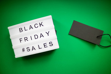 Minimal Flat Lay of light box and black label on green background