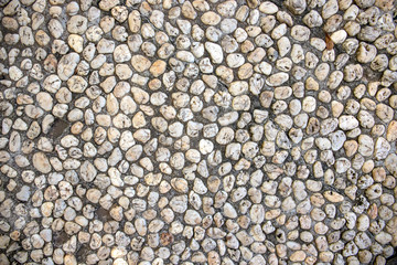 White pebble paving photo texture. Tiny marble gravel road. Pebble texture. Marine or seaside construction material.