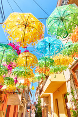 Fototapeta na wymiar Street decorated with umbrellas of different colours