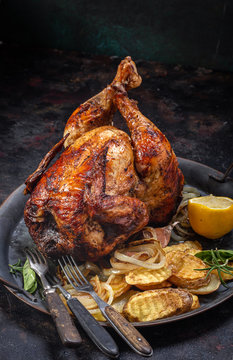 Grilled beer can chicken and vegetables on tray with copy space