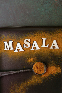Spoon of masala- indian spice mix with text