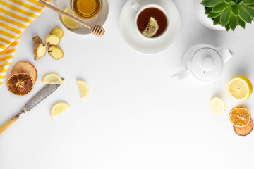Obraz na płótnie Canvas Ginger tea with lemon honey hot autumn, winter drink white background with copy space flat lay.