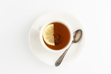 Black tea with lemon and honey on a white background. Hot tea cup isolated, top view flat lay. Flat lay. Autumn, fall or winter drink. Copy space.