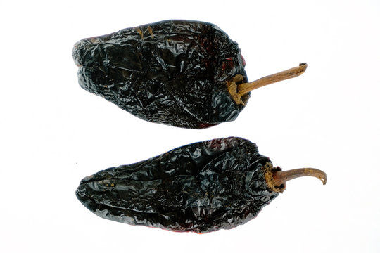 Isolated smoked dried pepper, Chile Ancho, or dried Poblano pepper, Capsicum annuum, on a white background
