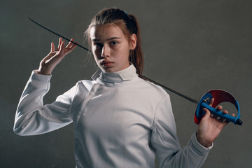 Fencer woman with fencing sword.