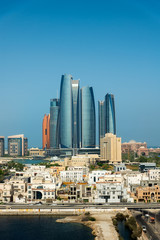 Abu Dhabi skyline view of the downtown buildings rising over the water