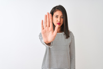 Young beautiful chinese woman wearing striped t-shirt standing over isolated white background doing...