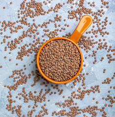 Organic dry lentils in a ceramic bowl.
