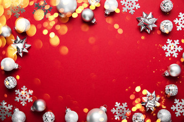 Christmas and New Year holiday background. Xmas greeting card. Christmas gifts and ornaments on red background top view.