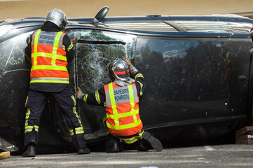  portrait on back view of french rescue man on crashed car