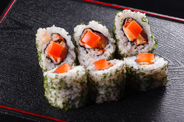 Japanese food, tasty of meal for lunch. Seafood. Sushi with eel, salmon, trout, tuna black background.