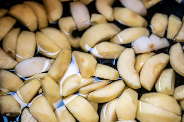 peeled and sliced apple slices floating in water