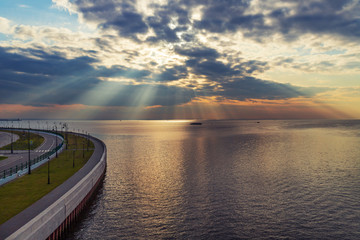 sun rays goes through the clouds over the Baltic sea,