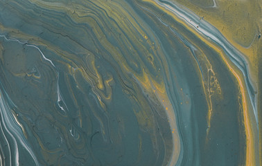 art photography of abstract marbleized effect background. gray, pewter blue and gold creative colors. Beautiful paint.