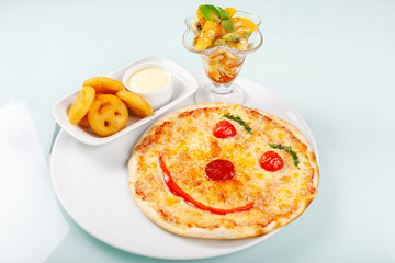 Pizza smiling. Italian dish with tomato sauce smile and parmesan cheese, fresh tomatoes, basil.