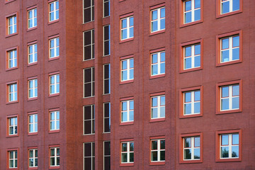 Fototapeta na wymiar Facade of office building with windows. Facade of an old red brick wall with windows. Old red brick wall with windows.
