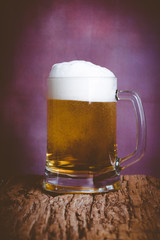 beer with foam on wooden 