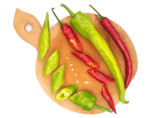 Hot peppers on a wooden board and on the white background
