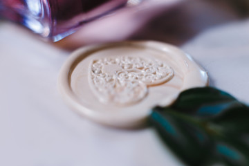imprint of a heart on white sealing wax