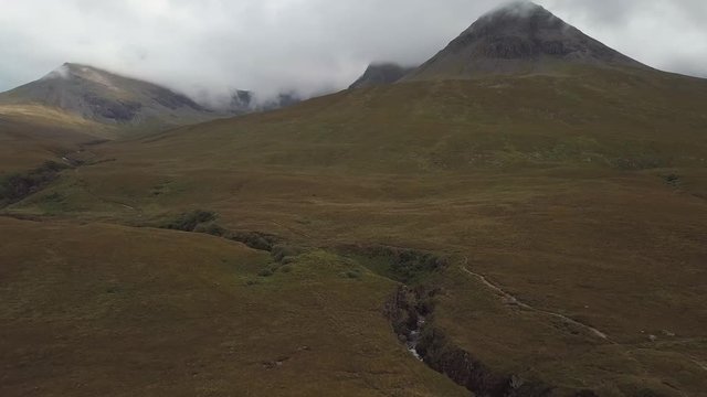 Aerial view of mountains peaks and waterfall in the mountains. Scottish Highlands