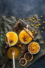 sea buckthorn tea with orange and spices on a dark background