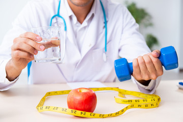 Young male doctor in sport and dieting concept