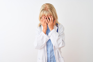 Middle age doctor woman wearing glasses and stethoscope over isolated white background with sad expression covering face with hands while crying. Depression concept.