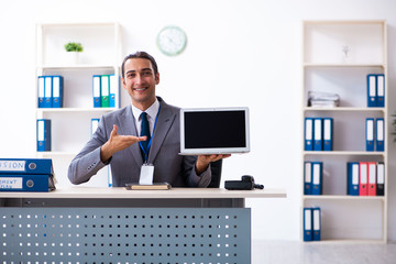 Young male accountant working in the office