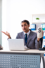 Young male accountant working in the office