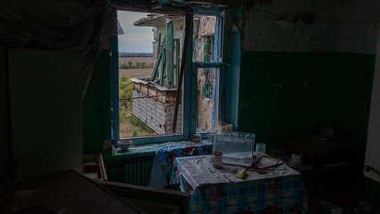 Krasnohorivka, Donetsk region/Ukraine - 24 September 2019: Destroyed by shelling houses and someone homes, the view through windows to Donetsk controlled by prorussian separatists 