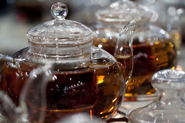 glass teapots with hot tea for a large number of guests