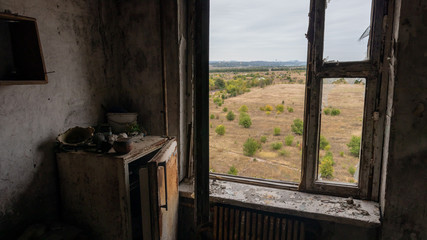 Fototapeta na wymiar Krasnohorivka, Donetsk region/Ukraine - 24 September 2019: Destroyed by shelling houses and someone homes, the view through windows to Donetsk controlled by prorussian separatists 