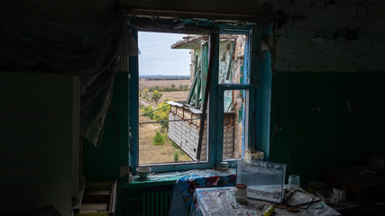 Krasnohorivka, Donetsk region/Ukraine - 24 September 2019: Destroyed by shelling houses and someone homes, the view through windows to Donetsk controlled by prorussian separatists 