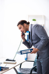 Young male accountant working in the office