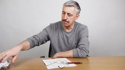 Man throws away paper documents in the basket. - Powered by Adobe
