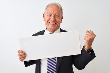 Senior businessman wearing suit holding banner over isolated white background screaming proud and celebrating victory and success very excited, cheering emotion