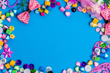 Mix of beads and beads on a blue background. The formation border is a frame with a blue color for the text. Mockup and abstract, colorful background. concept of needlework, creativity and a hobby.