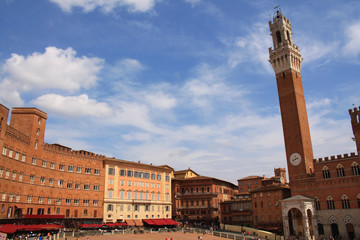 Fototapeta na wymiar Piazza del Campo with the Pubblico palace and Mangia tower , the principal public space of the historic center of Siena, Tuscany, Italy. It is regarded as one of Europe's greatest medieval squares