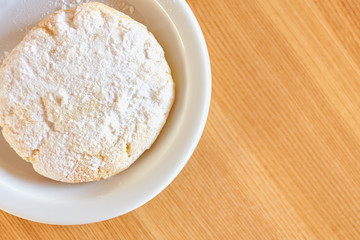 Powdered cookie for coffee on a wooden table, view from above.