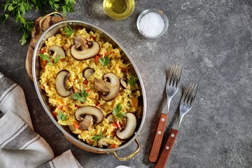 Paella or risotto with mushrooms, bell peppers, carrots, onions, white wine and olive oil. Homemade healthy food.