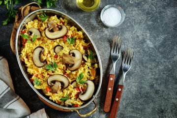 Paella or risotto with mushrooms, bell peppers, carrots, onions, white wine and olive oil. Homemade healthy food.