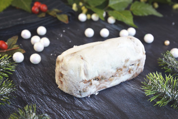 Full traditional German christmas season sweet food called 'Stollen' or 'Christstollen', a fruit bread of nuts, spices, and dried or candied fruit, coated with powdered sugar
