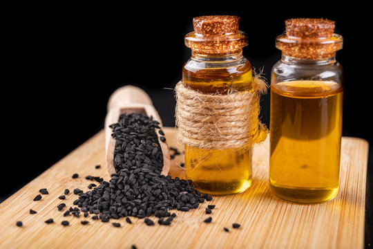 Healthy, cold pressed black cumin oil. Ingredients for a healthy diet in a modern kitchen.
