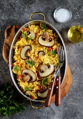 Paella or risotto with mushrooms, bell peppers, carrots, onions, white wine and olive oil. Homemade healthy food.