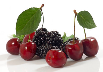 isolated image of ripe cherry and blackberry on a white background close-up