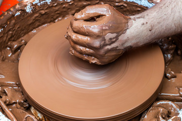 potter making small water container from soil