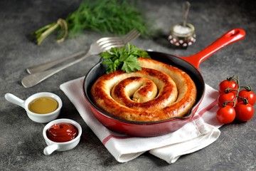 Grilled sausage in a cast iron pan. Delicious homemade food.