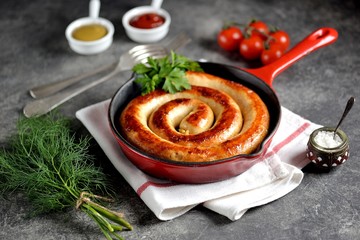 Grilled sausage in a cast iron pan. Delicious homemade food.