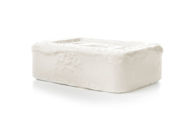 Soap bar with foam on white background